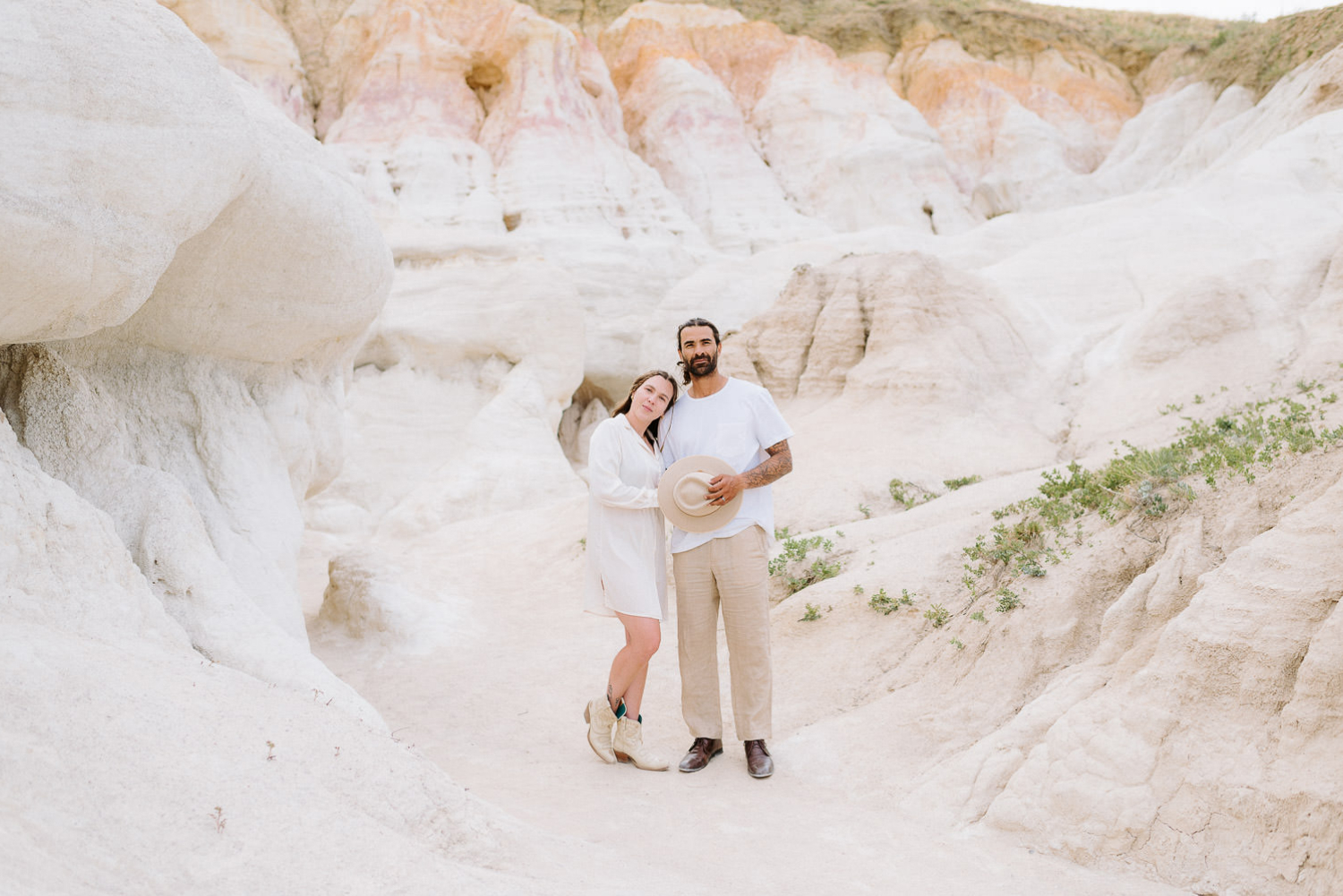 Couples stands in front of formations at Paint Mines Interpretive Park