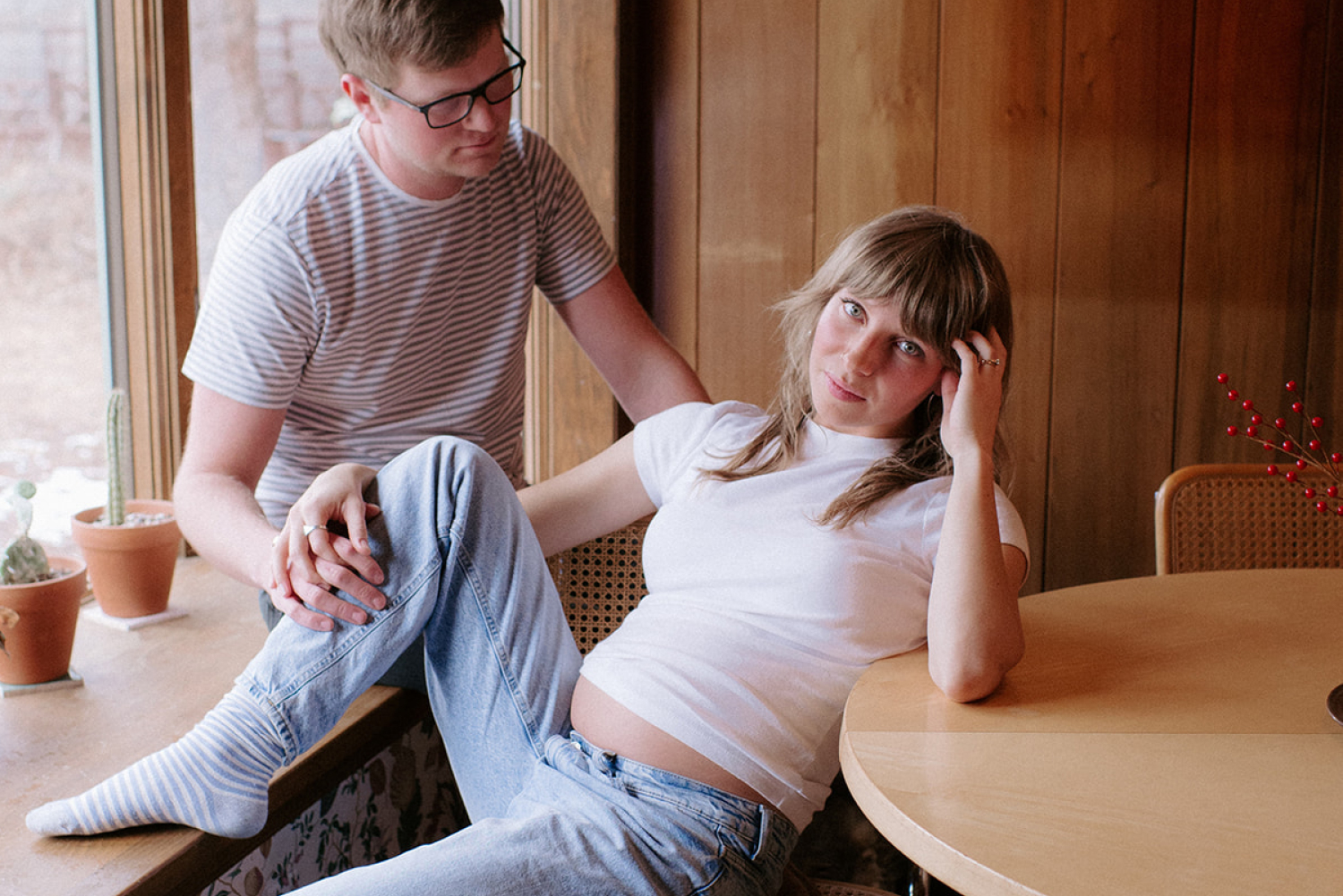 Husband and pregnant wife in mid century home