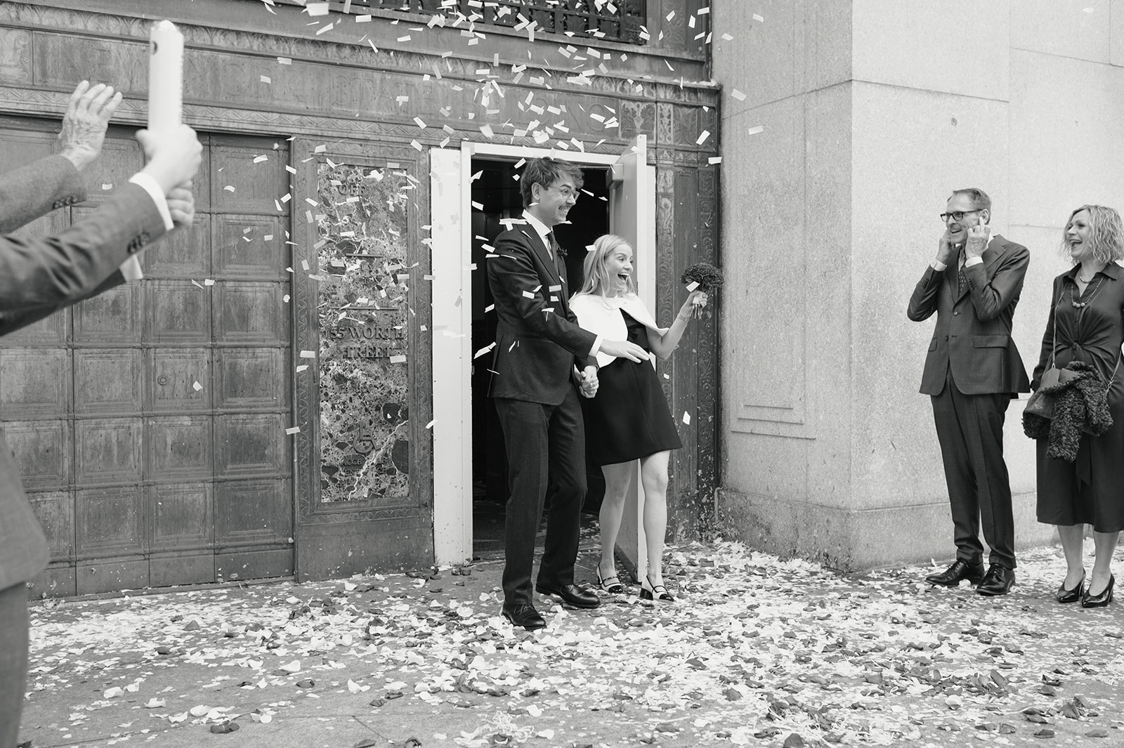bride and groom exiting manhattan city hall after their nyc wedding ceremony
